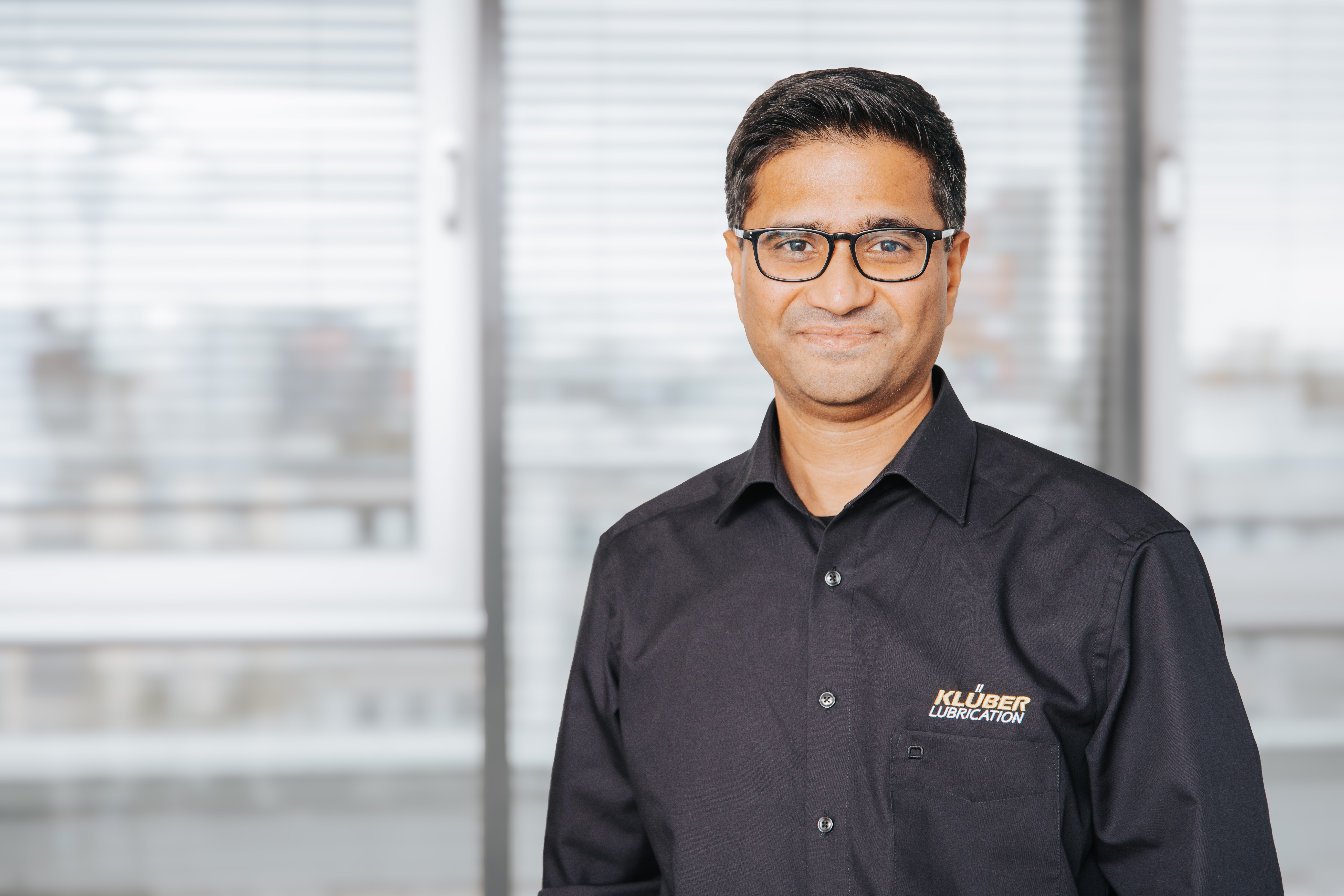 A smiling man with glasses