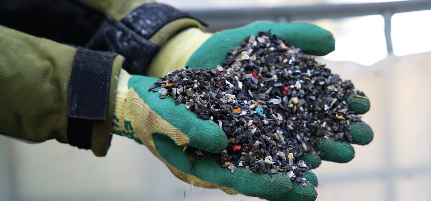 Gloved hands holding small bits of trash