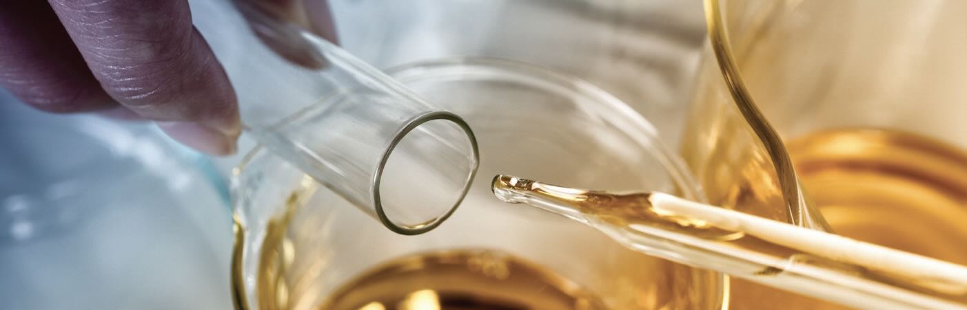 A pipette and test tube with golden liquid