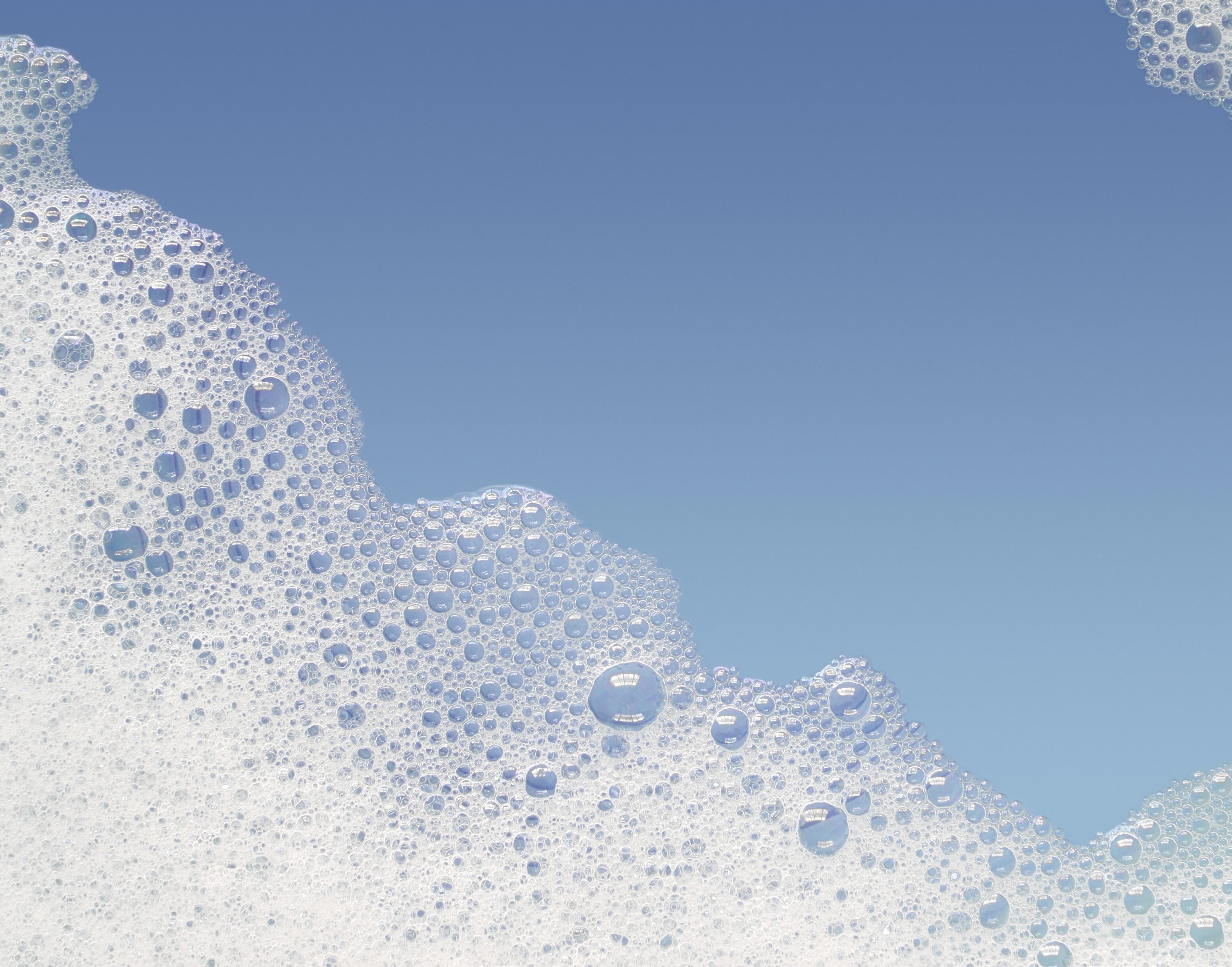 White foam bubbles on a blue background