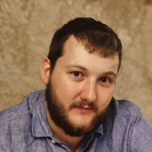 A professional headshot of a man