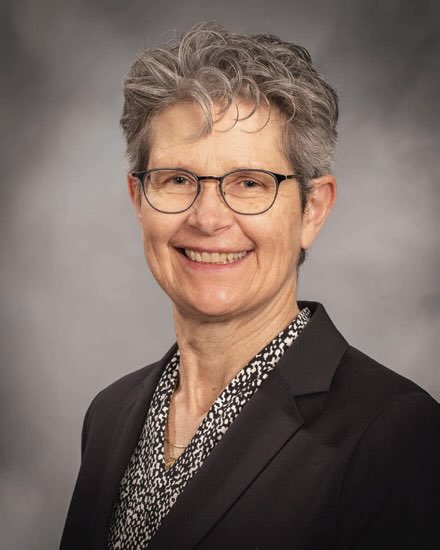 Photo of a smiling woman with glasses