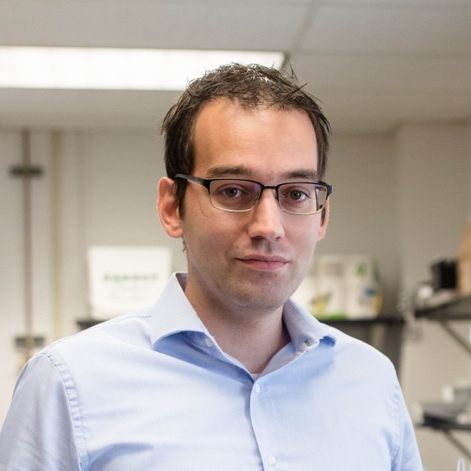 A photo of a man with glasses.