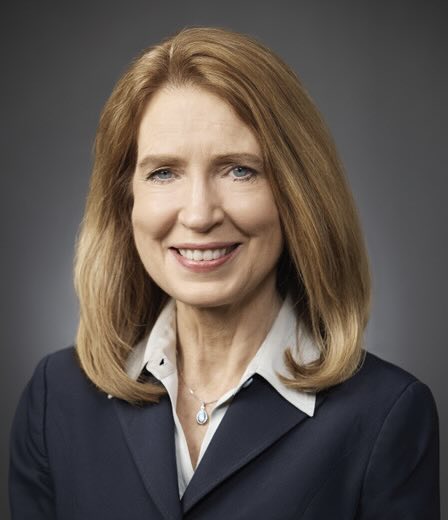 A photo of a smiling woman.