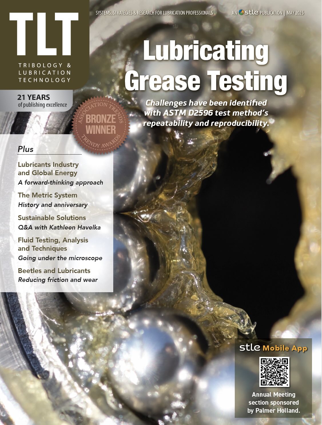 The cover of the May 2025 TLT, which shows an up close photo of a greased ball bearing.